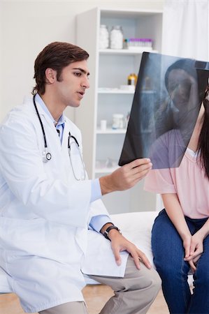 simsearch:400-05748252,k - Male doctor analyzing x-ray with his female patient Stock Photo - Budget Royalty-Free & Subscription, Code: 400-05747049