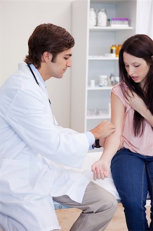 simsearch:400-05748252,k - Male doctor prepares patients arm for injection Stock Photo - Budget Royalty-Free & Subscription, Code: 400-05747040
