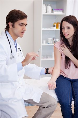 simsearch:400-05748252,k - Male doctor about to give an injection to patient Stock Photo - Budget Royalty-Free & Subscription, Code: 400-05747041
