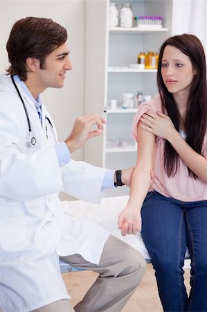 simsearch:400-05748252,k - Male doctor about to give an injection to female patient Stock Photo - Budget Royalty-Free & Subscription, Code: 400-05747042