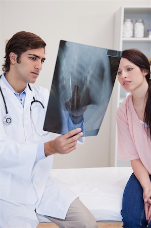 simsearch:400-05748252,k - Young doctor and patient looking at x-ray together Stock Photo - Budget Royalty-Free & Subscription, Code: 400-05747050
