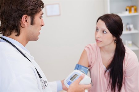 simsearch:400-05748252,k - Young woman getting her blood pressure checked Stock Photo - Budget Royalty-Free & Subscription, Code: 400-05747079