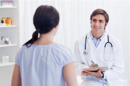 simsearch:400-05748252,k - Smiling young physician talking with patient Stock Photo - Budget Royalty-Free & Subscription, Code: 400-05747108