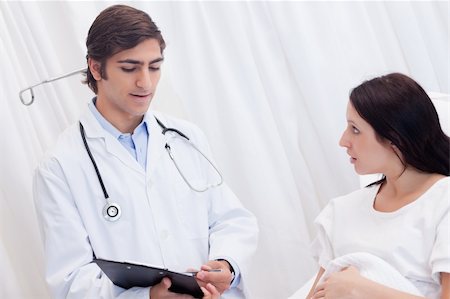 simsearch:400-05748252,k - Young doctor and patient talking about examination results Stock Photo - Budget Royalty-Free & Subscription, Code: 400-05747189