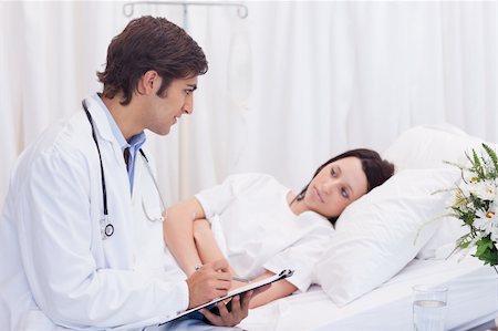 simsearch:400-05748252,k - Young doctor talking to his patient that just woke up Stock Photo - Budget Royalty-Free & Subscription, Code: 400-05747196
