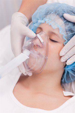 patient oxygen breathing - Young female patient with oxygen mask Stock Photo - Budget Royalty-Free & Subscription, Code: 400-05747191