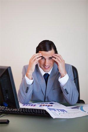 simsearch:400-05748170,k - Frustrated young businessman working on statistics Stock Photo - Budget Royalty-Free & Subscription, Code: 400-05748148