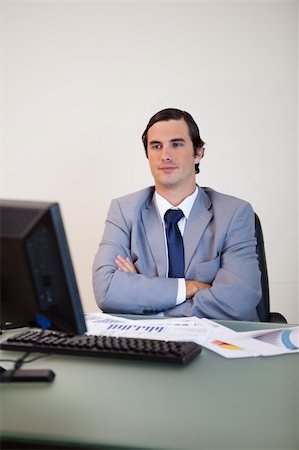 simsearch:400-05748170,k - Businessman with arms folded waiting for his computer to boot up Stock Photo - Budget Royalty-Free & Subscription, Code: 400-05748152