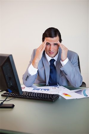 simsearch:400-05748170,k - Businessman experiencing a headache at his desk Stock Photo - Budget Royalty-Free & Subscription, Code: 400-05748168
