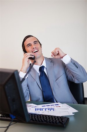 simsearch:400-05748170,k - Cheerful businessman on the phone raising hand Stock Photo - Budget Royalty-Free & Subscription, Code: 400-05748178