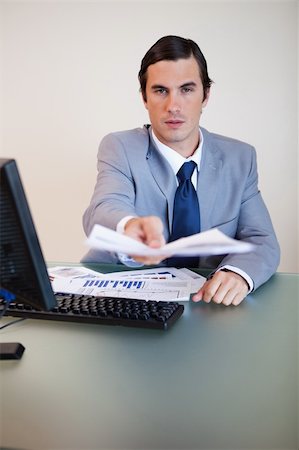 simsearch:400-05748170,k - Businessman at his desk handing over contract Stock Photo - Budget Royalty-Free & Subscription, Code: 400-05748171