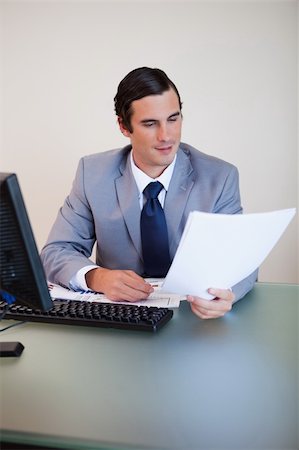 simsearch:400-05748170,k - Businessman having a look at a contract in his hand Stock Photo - Budget Royalty-Free & Subscription, Code: 400-05748173