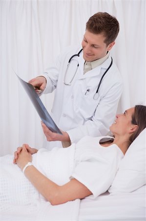simsearch:400-05748252,k - Doctor showing x-ray to his bedridden patient Stock Photo - Budget Royalty-Free & Subscription, Code: 400-05748255