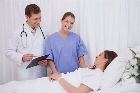 simsearch:400-05748252,k - Doctors bringing good news to bedridden patient Stock Photo - Budget Royalty-Free & Subscription, Code: 400-05748257