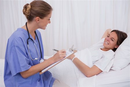simsearch:400-05748252,k - Surgeon talking with bedridden patient Stock Photo - Budget Royalty-Free & Subscription, Code: 400-05748270