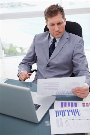 simsearch:400-05748170,k - Businessman with market research results leaning back in his chair Stock Photo - Budget Royalty-Free & Subscription, Code: 400-05748284