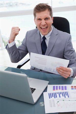 simsearch:400-04113367,k - Businessman at his desk celebrating market research results Stock Photo - Budget Royalty-Free & Subscription, Code: 400-05748287