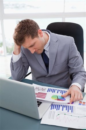 simsearch:400-05748170,k - Businessman at his desk frustrated by market research results Stock Photo - Budget Royalty-Free & Subscription, Code: 400-05748288