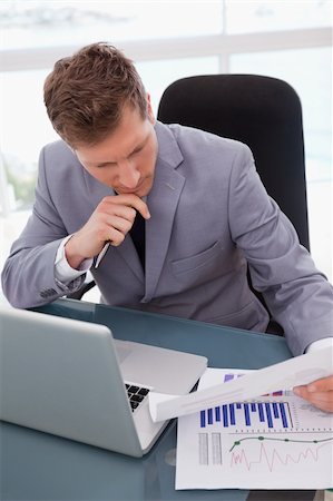 simsearch:400-05748170,k - Businessman at his desk looking at market research results Stock Photo - Budget Royalty-Free & Subscription, Code: 400-05748282