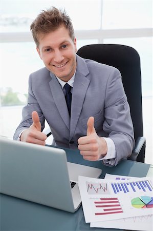 simsearch:400-05748170,k - Happy businessman at his desk giving thumbs up Stock Photo - Budget Royalty-Free & Subscription, Code: 400-05748291