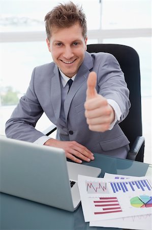simsearch:400-05748170,k - Happy businessman at his desk giving thumb up Stock Photo - Budget Royalty-Free & Subscription, Code: 400-05748292