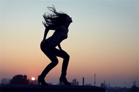 erotic female figures - silhouette of slim seductive woman standing on  rooftop at sunset. urban background Stock Photo - Budget Royalty-Free & Subscription, Code: 400-05748503