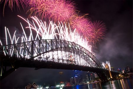 Sparkling New Year Eve nye Fireworks in Sydney Harbour Sky Line At Night, NSW, Australia, Oceania. The Sydney harbour bridge and sydney opera house sparkling in the night. Colourful surface. Night scene Stock Photo - Budget Royalty-Free & Subscription, Code: 400-05748719