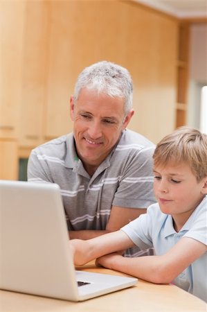 simsearch:400-05751173,k - Portrait of a boy and his father using a notebook in a kitchen Stock Photo - Budget Royalty-Free & Subscription, Code: 400-05749512