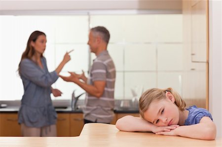 Sad little girl listening her parents having an argument in a kitchen Stock Photo - Budget Royalty-Free & Subscription, Code: 400-05749586