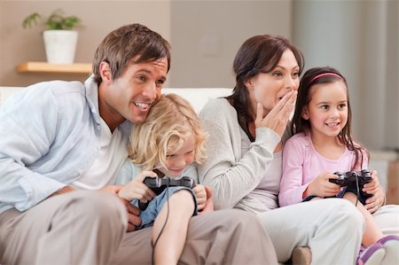 simsearch:400-05749633,k - Competitive family playing video games in a living room Stock Photo - Budget Royalty-Free & Subscription, Code: 400-05749667