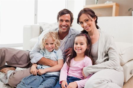 simsearch:400-04193348,k - Family relaxing on a sofa in a living room Stock Photo - Budget Royalty-Free & Subscription, Code: 400-05749700