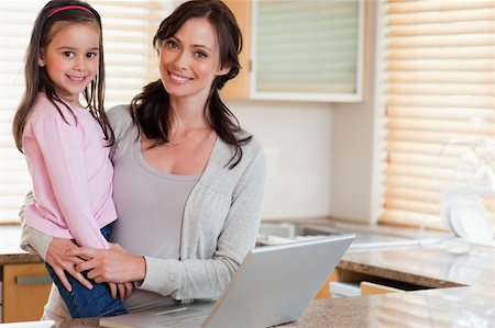 simsearch:400-05751173,k - Girl and her mother using a notebook in a kitchen Stock Photo - Budget Royalty-Free & Subscription, Code: 400-05749727
