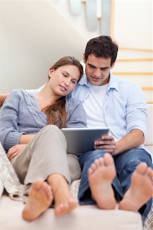 feet face - Portrait of a couple using a tablet computer in their living room Stock Photo - Budget Royalty-Free & Subscription, Code: 400-05740012