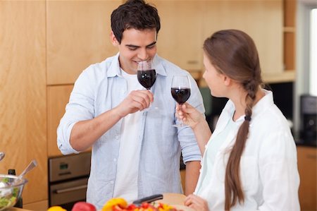 simsearch:400-05740111,k - Couple drinking a glass of red wine in their kitchen Stock Photo - Budget Royalty-Free & Subscription, Code: 400-05740097