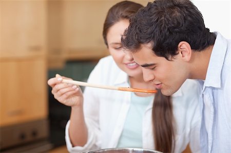 simsearch:400-05740111,k - Close up of a man trying his wife's sauce in their kitchen Stock Photo - Budget Royalty-Free & Subscription, Code: 400-05740109