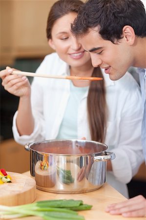 simsearch:400-05740111,k - Portrait of a man trying his wife's sauce in their kitchen Stock Photo - Budget Royalty-Free & Subscription, Code: 400-05740110