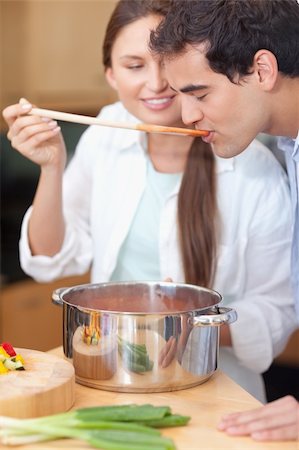 simsearch:400-05740111,k - Portrait of a young man trying his wife's sauce in their kitchen Stock Photo - Budget Royalty-Free & Subscription, Code: 400-05740111