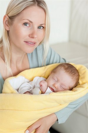 premature - Young mom holding her sleeping baby that is wrapped up in a cover Stock Photo - Budget Royalty-Free & Subscription, Code: 400-05741288