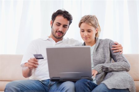 simsearch:400-04410667,k - Couple shopping online in their living room Stock Photo - Budget Royalty-Free & Subscription, Code: 400-05741546