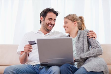 simsearch:400-04410667,k - Young couple shopping online in their living room Stock Photo - Budget Royalty-Free & Subscription, Code: 400-05741547