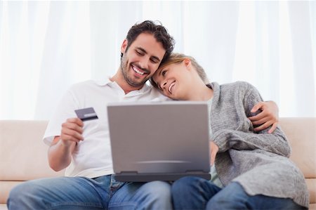 simsearch:400-04410667,k - Happy couple shopping online in their living room Stock Photo - Budget Royalty-Free & Subscription, Code: 400-05741549