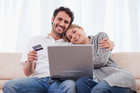 simsearch:400-04410667,k - Smiling couple shopping online in their living room Stock Photo - Budget Royalty-Free & Subscription, Code: 400-05741551