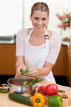 simsearch:400-05740111,k - Portrait of a smiling woman cooking in her kitchen Stock Photo - Budget Royalty-Free & Subscription, Code: 400-05741866