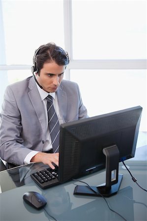 simsearch:400-03933798,k - Portrait of a sales assistant working with a monitor in his office Stock Photo - Budget Royalty-Free & Subscription, Code: 400-05741958