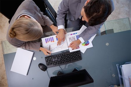 simsearch:400-05710386,k - Young business team studying statistics in a meeting room Stock Photo - Budget Royalty-Free & Subscription, Code: 400-05741965