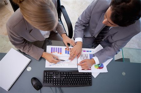 simsearch:400-05710386,k - Serisous business team studying statistics in a meeting room Stock Photo - Budget Royalty-Free & Subscription, Code: 400-05741966