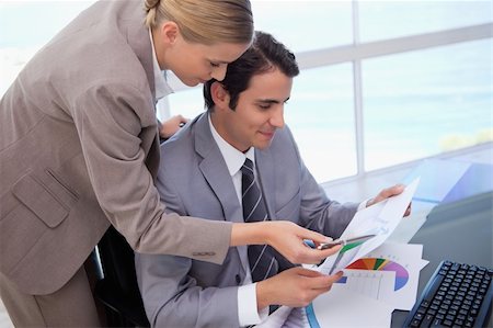 simsearch:400-05710386,k - Manager pointing at something to her employee on a graph in his office Stock Photo - Budget Royalty-Free & Subscription, Code: 400-05741972