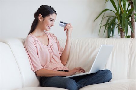 simsearch:400-04410667,k - Smiling woman shopping online in her living room Stock Photo - Budget Royalty-Free & Subscription, Code: 400-05742014