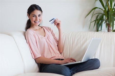 simsearch:400-04410667,k - Joyful woman shopping online in her living room Stock Photo - Budget Royalty-Free & Subscription, Code: 400-05742016