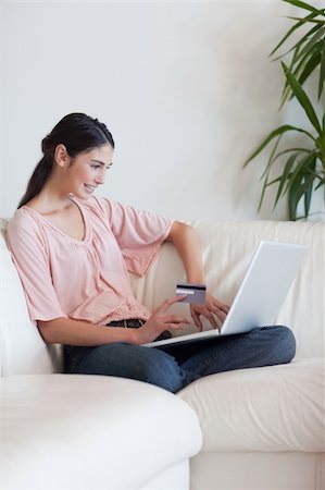 simsearch:400-04410667,k - Portrait of a woman shopping online in her living room Stock Photo - Budget Royalty-Free & Subscription, Code: 400-05742011